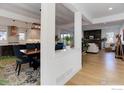 Inviting living room featuring hardwood floors and seamless connection to kitchen at 785 Delechant Dr, Erie, CO 80516