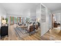 Bright living room with hardwood floors and access to a balcony with city views at 800 N Washington St # 409, Denver, CO 80203