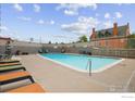 Outdoor pool with lounge chairs and a charming building in the background at 800 N Washington St # 409, Denver, CO 80203