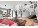 Bright living room with hardwood floors, a staircase, and lots of natural light at 823 Timothy Dr, Longmont, CO 80503
