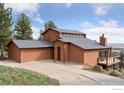 Charming home featuring a spacious garage, unique architectural details, and appealing curb appeal at 8654 Thunderhead Dr, Boulder, CO 80302