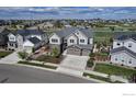 Expansive aerial view of a two-story home in a Gathering-friendly neighborhood with nearby green spaces at 913 Green Mountain Dr, Erie, CO 80516