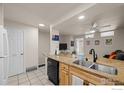 Open concept kitchen featuring granite countertops, stainless steel sink, and black appliances at 1065 University Ave # 121, Boulder, CO 80302