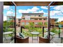 Cozy balcony features seating area with lovely neighborhood views and cloudscape at 1077 Canyon Blvd # 211, Boulder, CO 80302