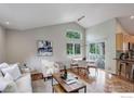 Open-concept living area with dining space, hardwood floors, and natural light at 109 Gold Hill Dr, Lafayette, CO 80026