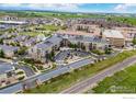 Aerial view of condo community featuring guest parking, beautifully landscaped grounds, and a convenient entrance at 13598 Via Varra # 404, Broomfield, CO 80020