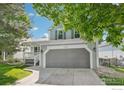 Traditional two-story home with a two-car garage and a covered porch at 14418 W Yale Pl, Lakewood, CO 80228