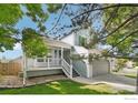 Inviting two-story home featuring a welcoming porch and attached two-car garage at 14418 W Yale Pl, Lakewood, CO 80228