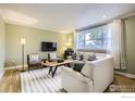 Bright living room with large window, white sofa and stylish furnishings perfect for relaxation or entertaining guests at 1510 22Nd Ave, Longmont, CO 80501
