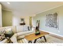 Comfortable living room with light green walls, wood floors, stylish decor and a large sofa for relaxing at 1510 22Nd Ave, Longmont, CO 80501
