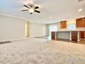 Open-concept living room featuring carpet, ceiling fan, and easy access to kitchen at 17913 County Road 38, Platteville, CO 80651