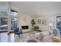 Bright living room with hardwood floors, fireplace, and large windows at 1880 Kohler Dr, Boulder, CO 80305