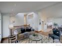 Open-concept living room with hardwood floors and comfortable seating at 1880 Kohler Dr, Boulder, CO 80305