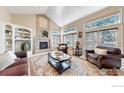 Cozy living room with a fireplace, large windows, and an elegant area rug at 1977 Champions Cir, Castle Rock, CO 80104