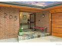 Inviting front entry with stylish tile steps, a bench, and a charming wooden door at 205 Lipan Way, Boulder, CO 80303