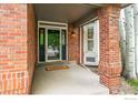 Inviting entryway featuring a brick facade, transom window, and stylish 'hello' doormat at 2204 Lasalle St, Superior, CO 80027