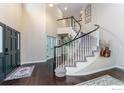 Grand foyer with a soaring ceiling, dark wood floors, and a curved staircase at 2204 Lasalle St, Superior, CO 80027