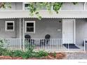 Cozy front porch with chairs, offering a relaxing outdoor space with a view of the well-kept front yard at 2565 Pierce St, Lakewood, CO 80214
