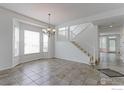 Open dining area with access to the stairway and an abundance of natural light from multiple windows at 2631 E 136Th Pl, Thornton, CO 80602