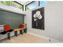 Bright entryway nook featuring a wooden bench, decorative pillows, and a striking leaf painting at 2860 Table Mesa Dr, Boulder, CO 80305