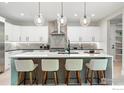 Stylish kitchen features a large center island with seating and modern pendant lighting at 2860 Table Mesa Dr, Boulder, CO 80305
