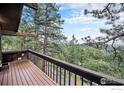Enjoy beautiful scenic views from the deck surrounded by lush trees and mountain scenery at 335 Wild Horse Cir, Boulder, CO 80304