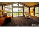 Inviting living room featuring floor to ceiling windows with mountain views and comfortable seating at 335 Wild Horse Cir, Boulder, CO 80304