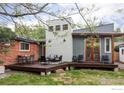 Inviting backyard features a wooden deck with seating and a well-maintained lawn at 3445 Martin Dr, Boulder, CO 80305