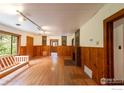Spacious living room with wood floors, a charming fireplace, and large windows at 35106 Boulder Canyon Dr, Boulder, CO 80302