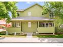 Inviting home with a cozy porch, featuring a comfortable rocking chair and lush green landscaping at 4620 15Th St # C, Boulder, CO 80304