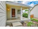 Inviting front porch with a well-maintained lawn and tranquil curb appeal at 5023 Goshawk Ct, Brighton, CO 80601