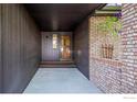 Covered entrance with brick accents and a charming wooden door at 5430 Baca Cir, Boulder, CO 80301