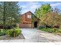 Beautiful home with a well-manicured lawn, mature trees, and a spacious driveway at 5430 Baca Cir, Boulder, CO 80301