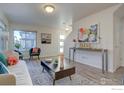Bright living room featuring modern decor, stylish furniture, and large windows for natural light at 5863 Boston St, Denver, CO 80238