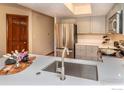 Modern kitchen featuring stainless steel appliances, gray cabinets, and white countertop with a large sink at 5950 Gunbarrel Ave # E, Boulder, CO 80301