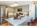 Beautiful kitchen featuring stainless steel appliances, light gray cabinets, and a white countertop breakfast bar at 5950 Gunbarrel Ave # E, Boulder, CO 80301