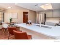 Bright kitchen featuring stainless steel appliances, light gray cabinets, and a white countertop breakfast bar at 5950 Gunbarrel Ave # E, Boulder, CO 80301