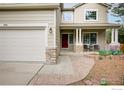 Inviting home exterior with a covered porch and a well-maintained front yard at 804 Nelson Park Ln, Longmont, CO 80503