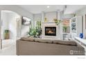 Cozy living room with a fireplace, large windows, and a comfortable couch for relaxation and entertaining at 820 Kimbark St # D, Longmont, CO 80501