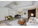 Bright living room boasts a stone fireplace, piano, and plenty of space for comfortable seating at 849 Mountain Meadows Rd, Boulder, CO 80302