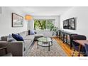 Sun-lit living room with stylish furniture, hardwood floors, and large window at 1201 Balsam Ave # 201, Boulder, CO 80304