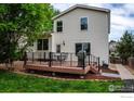 Charming backyard with a deck perfect for entertaining and green grass at 1309 Red Mountain Dr, Longmont, CO 80504