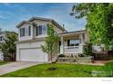 Beautiful two-story house with a front porch, two car garage, and well-maintained lawn at 1309 Red Mountain Dr, Longmont, CO 80504