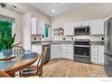 Efficient kitchen featuring stainless steel appliances and a cozy eat-in dining area at 1309 Red Mountain Dr, Longmont, CO 80504