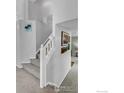 Bright staircase with carpeted steps and white railing leading to the upper level at 1309 Red Mountain Dr, Longmont, CO 80504