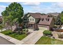Beautiful two-story home featuring a landscaped front yard, brick accents, and attached garage at 13445 Kearney St, Thornton, CO 80602