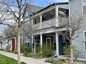 Two-story home featuring a covered porch with white railings, complemented by a red front door at 1400 Lee Hill Dr # 1, Boulder, CO 80304