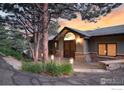 Beautiful entrance featuring stone accents, wooden doors, and attractive outdoor lighting at 142 Meadowlook Way, Boulder, CO 80304