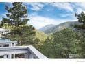 Scenic view of the mountains and surrounding trees from the deck of this home at 142 Meadowlook Way, Boulder, CO 80304