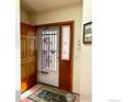 Inviting entryway with tile flooring, coat closet, and storm door at 1515 Tulip Ct, Longmont, CO 80501
